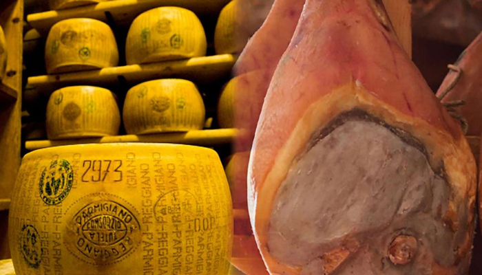 forma-di-formaggio-parmigiano-reggiano-vicino-a-un-violino-intero-di-prosciutto-crudo-di-parma